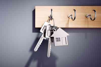 Schlüsselbund mit Schlüsselanhänger in Hausform auf Schlüsselwand - © peterschreiber.media - stock.adobe.com